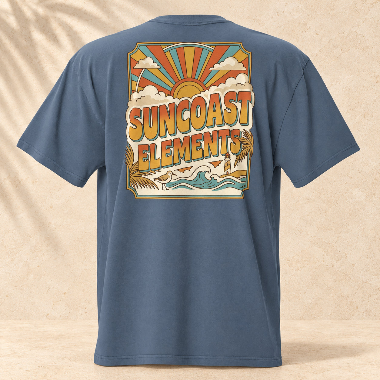 Sun Coast Off-Duty Oversized Faded Tee on pale coastal limestone with palm shadows